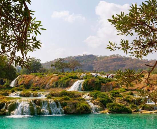Human migration out of Africa seems to have had a long pause in the Arabian Peninsula, acclimatizing, and perhaps enjoying water sources such as these at Wadi Darbat in the Dhofar region of Oman.	Source: hyserb/Adobe Stock