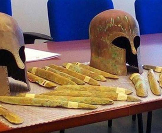 Some of the orichalcum ingots and the two Corinthian helmets found near a 2,600-year-old shipwreck off the coast of Sicily. 
