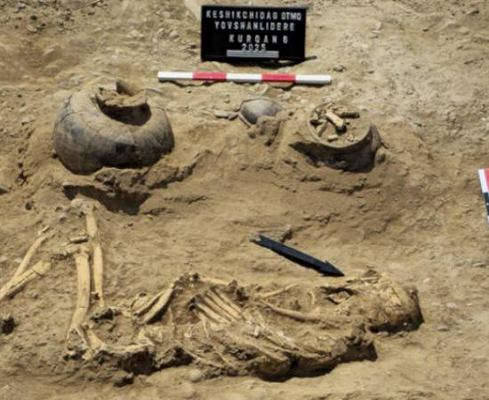 The skeletal remains of the burial with associated grave goods. 