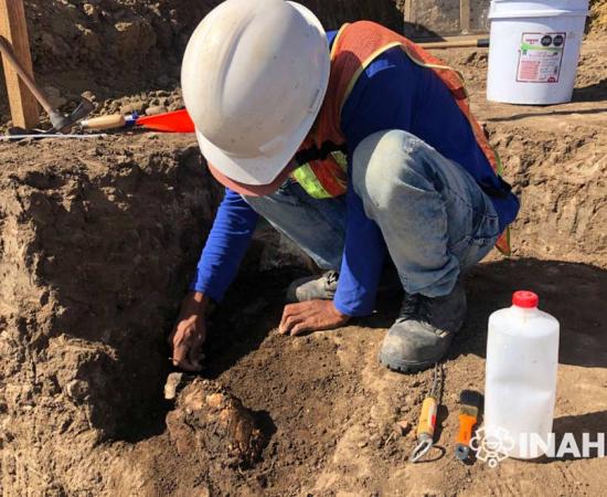 An archaeologist excavates a ceramic artifact at the pre-Hispanic Aztatlán culture settlement in Mexico, hidden beneath the urban sprawl of the west coast port city of Mazatlán.	Source: INAH