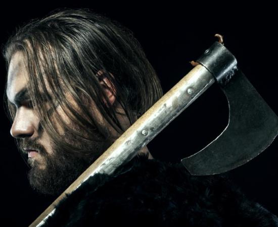 Medieval battle reenactor defended his home using an ancient battle ax. Source: alexmina / Adobe Stock.