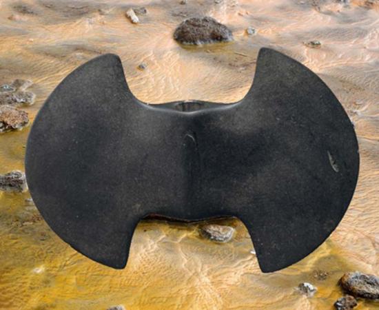 A bannerstone, the Metropolitan Museum of Art. (CC0) Background: Rocks and water. (CC0)