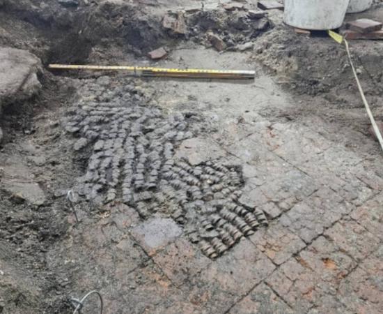 Tile floor patched with cow bones, found during excavations in Alkmaar city center.