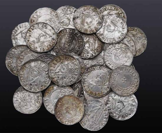 The Braintree hoard of 122 Anglo-Saxon pennies, found in Essex, England.      Source: Noonans