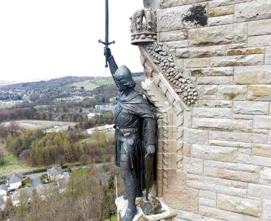 William Wallace statue stands proudly. The National Wallace Monument is a tower standing on a hilltop in Stirling in Scotland. Source: Jacek/Adobe Stock