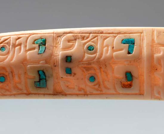 A bone carved with designs that depict a catfish and inlaid with pieces of turquoise. (Image credit: Shaanxi Academy of Archaeology)
