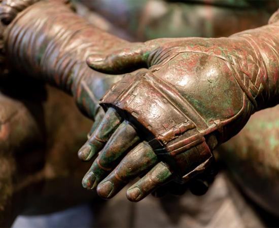 Details of an ancient Roman bronze statue. Credit: giorgio / Adobe Stock