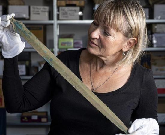 Martina Bekova of the Rychnov Museum with the Bronze age sword.             Source: David Tanecek, CTK