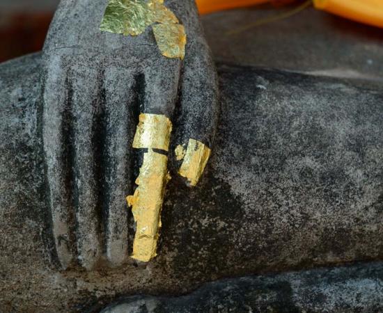 Buddha’s finger became a sacred relic of healing and well-being in Buddhism faith.  Statue Source: Natthapong/Adobe Stock