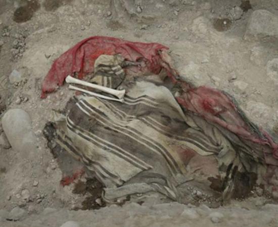 Human remains and textile found in a burial at the Huaca Bellavista archaeological site in Peru.