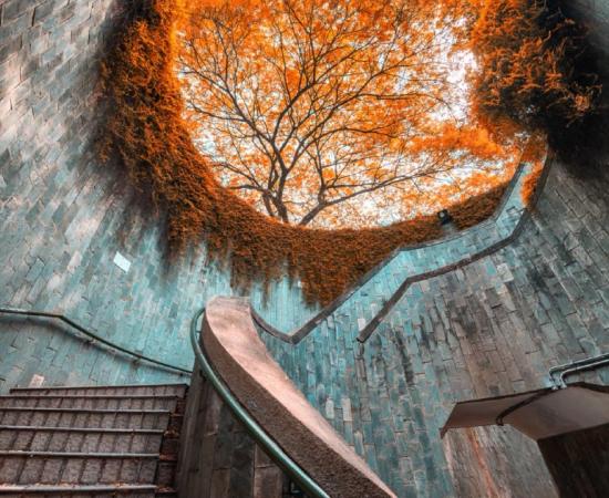 Spiral staircase of underground crossing in tunnel at Fort Canning Park, Singapore Source: (martinhosmat083/ Adobe Stock)