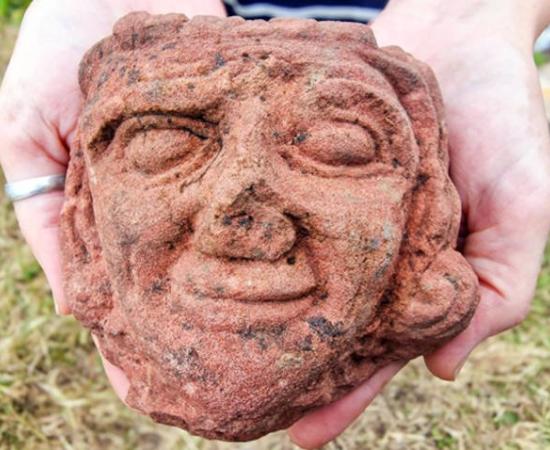 An intricately carved medieval sandstone head discovered during archaeological excavations at Skaill Farm on the island of Rousay, Orkney