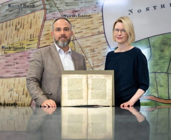 Dr Katie Walter and Dr James Wade in The Keep archive with the Tudor manuscript