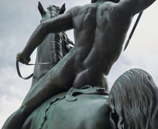 Bronze statue torso detail of a butt-naked horseman