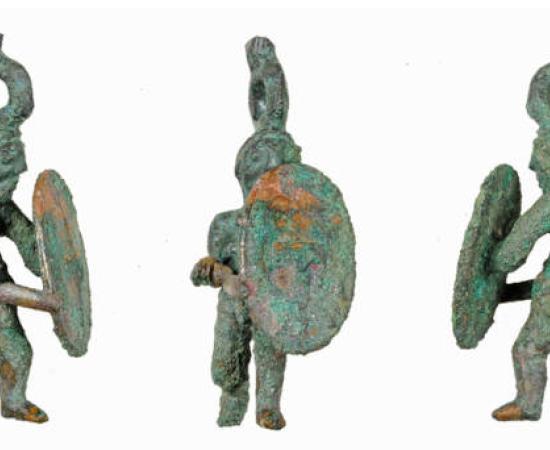 The Celtic warrior statuette after restoration, depicting a warrior in lunging pose with sword and shield