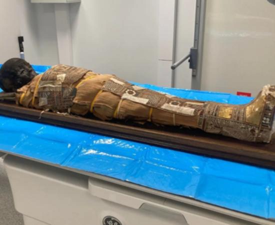 The 2,000-year-old Egyptian child mummy resting on a table before examination. 