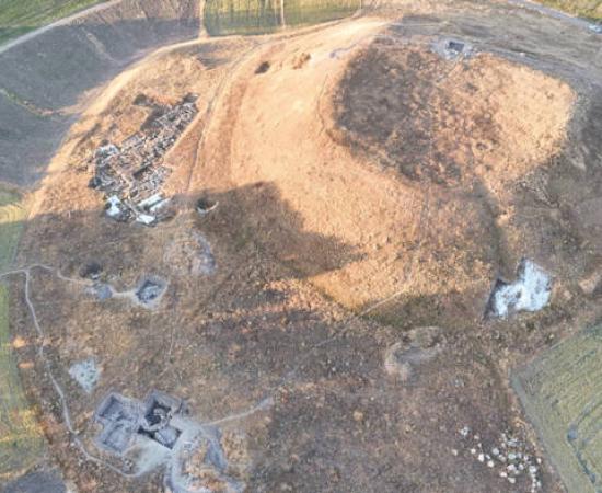 Aerial view of Uşaklı Höyük archaeological excavation showing large mound