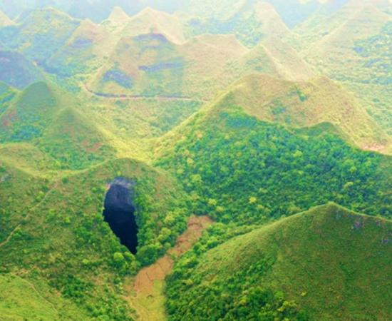 An aerial photo of the giant China sinkhole or tiankeng at Leye-Fengshan Global Geopark, in south China's Guangxi Province, which was huge and is home to an amazing primeval forest. Source: Zhou Hua / Xinhua