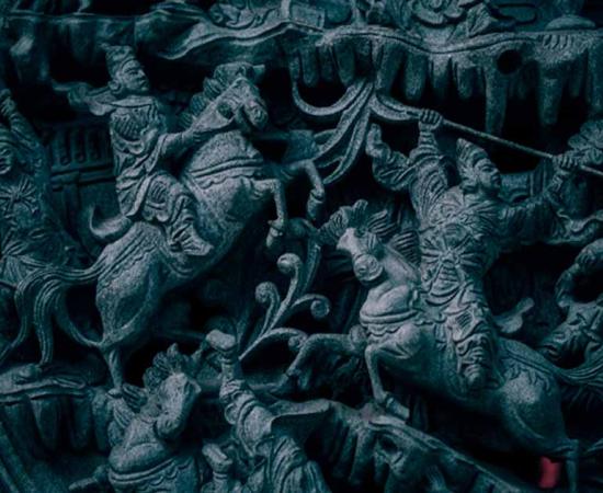 A representation of an ancient Chinese battle scene. Stunning stone carved architecture. Source: Igor/AdobeStock