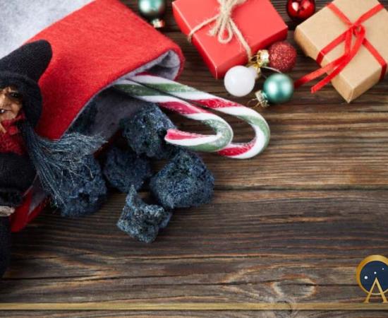The Befana with sweet coal and candy on wooden background. Italian Epiphany day tradition (vetre/Adobe Stock)