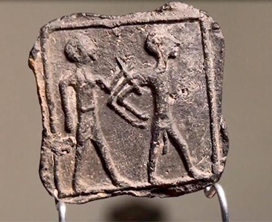 Clay plate discovered in Tell Jemmeh, Israel. Source: Emil Elgem / IAA.
