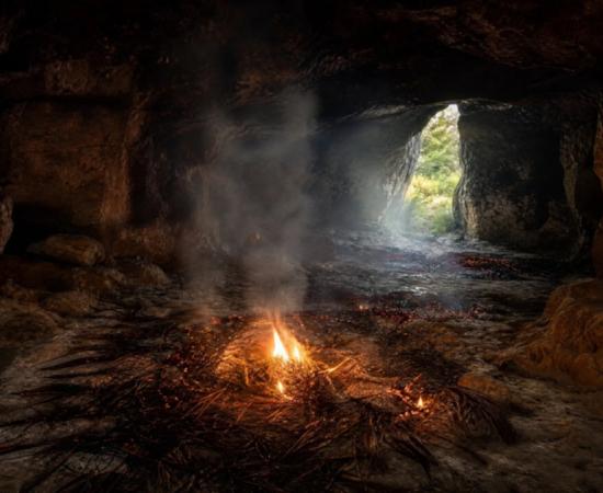 representations of Cloggs Cave Interior with grass burning on the cave floor.