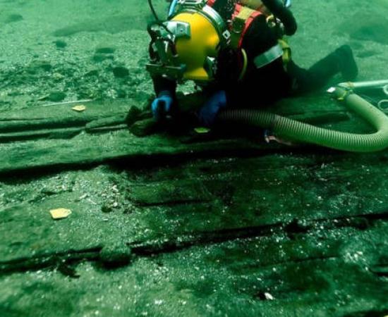 Medieval cog shipwreck underwater excavation showing divers at work on Svælget 2 