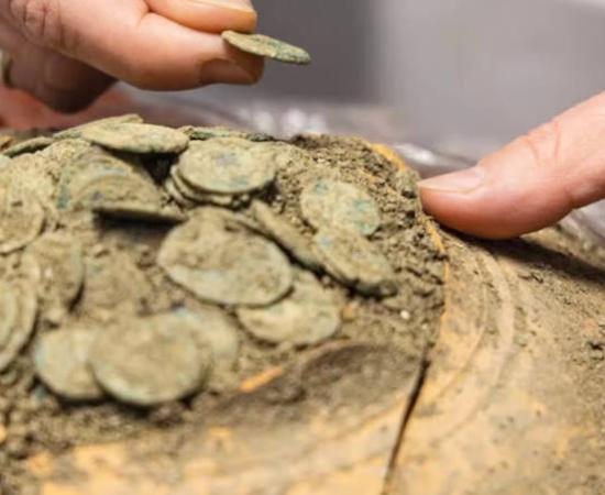 Vessel of Roman coins found in France.