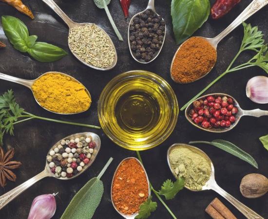 Culinary and medicinal spices and herbs on a wooden board