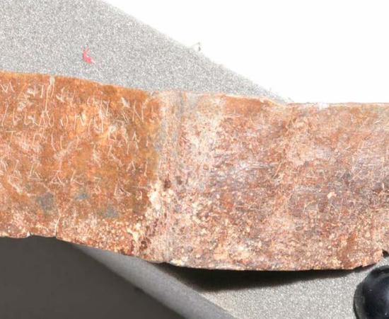Faded Cyrillic script discovered on lead plate. Source: Ivaylo Kanev/Bulgarian National History Museum