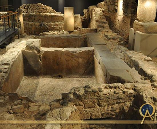 Remains of an ancient Roman salt fish factory and garum factory in the archaeological underground ruins at Plaça del Rei. 