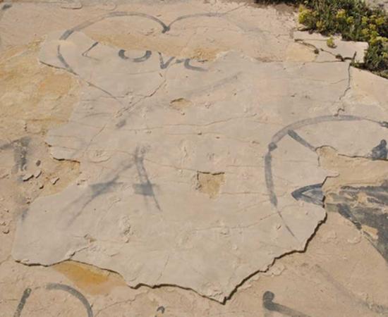 Vandalised site, showing fresh sand along the edges of the slab where it has been lifted and the holes left by the removal of two blocks in the centre. Babis Fassoulas, Author provided