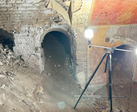 Arched doorways and colorful frescoes inside the Domus Liceo Cavour beneath the school gym