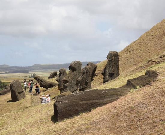 Statue heads on Easter Island in various stages of completion before they were abandoned in a crater.   