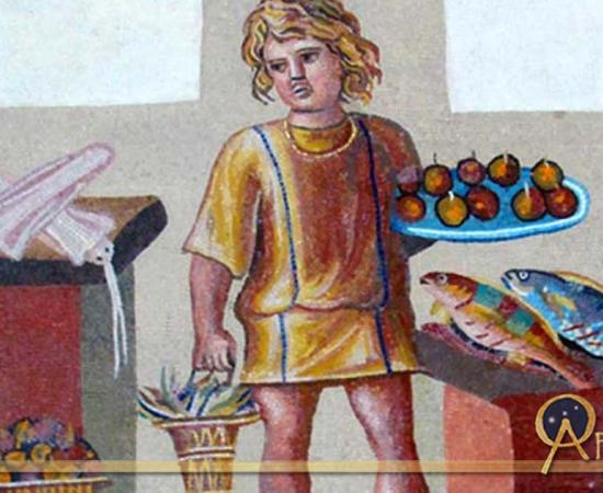 A boy holding a platter of fruits with a bucket of crabs, in a kitchen with fish and squid, on the June panel from a mosaic depicting the months (3rd century)