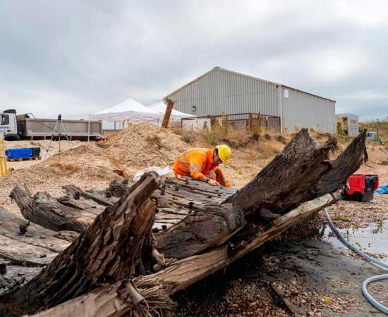 Archaeologist records the Elizabethan era ship’s remains on-site. Source: Wessex Archaeology