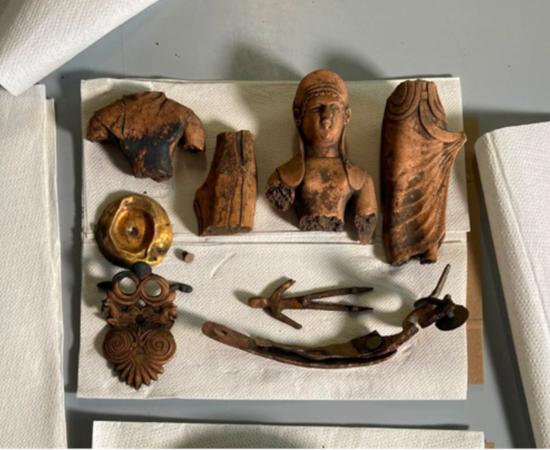 Two bronze statuettes and a rare bronze plate recovered from the Etruscan well in Kainua, modern Italy.