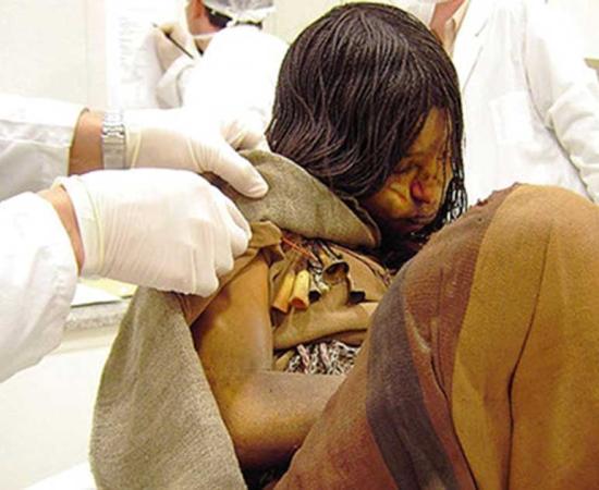 Llullaillaco mummy being examined by scientists (CC by 2.0)