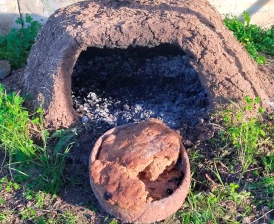 Focaccia, with animal fat experimentally baked in a replica husking tray inside a domed oven.	