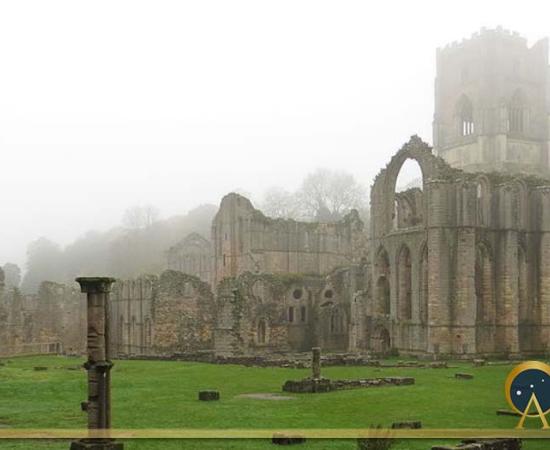 Fountain Abbey grounds enveloped in morning mist, from the Infirmary (DrMoschi /CC BY-SA 4.0)