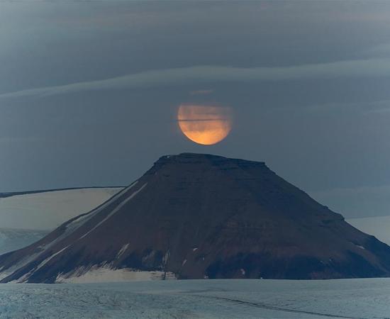 1110 AD was the year volcanic eruptions caused the disappearance of the Moon and sparked global famine. Pictured: representation of the Moon over a volcano. Source: Daniel / Adobe stock
