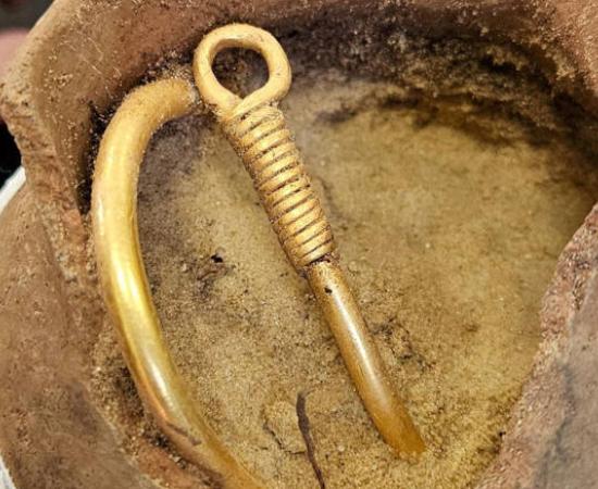  Gothic gold necklace in the clay pot in which it was found.