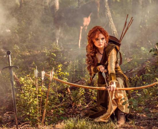 Representation of the ancient Greek goddess Artemis in the wood hunting. Source: gilitukha/ Adobe Stock 