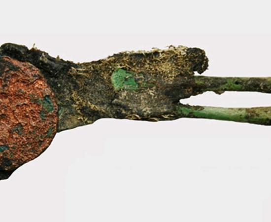 The baby had been partially mummified and had green bones due to copper from a coin placed in its hand.