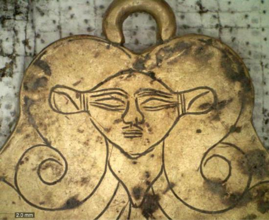 One of the tombs found by the grave of the Griffin Warrior at Pylos includes a gold pendant featuring the likeness of Hathor, an Egyptian goddess who was a protector of the dead. Source: UC Classics