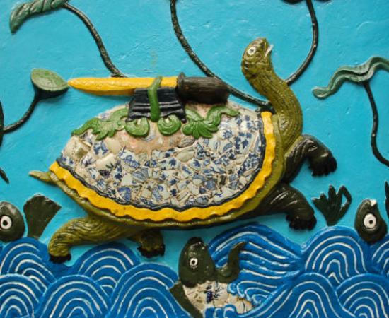 Ceramic artwork depicting Kim Quy and the Restored (or Returned) Sword. 