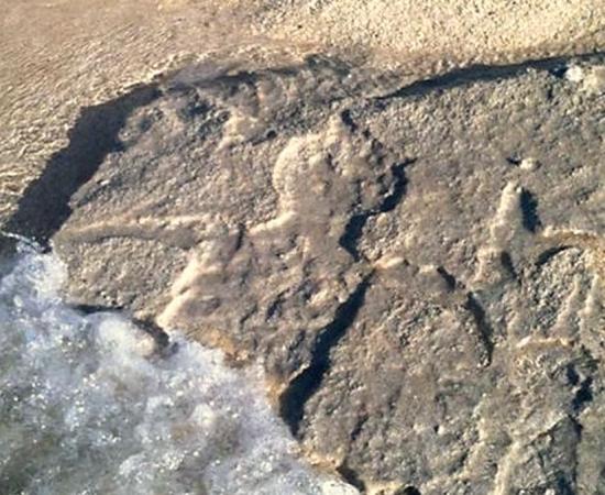 A petroglyph photographed on the Pine Trees beach of the Big Island in Hawaii. 