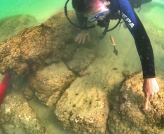 Archaeologists examine the remains of an ancient fortress off the coast of Dor Beach, Israel, March 19, 2019. Credit: Hagai Nativ / Haaretz