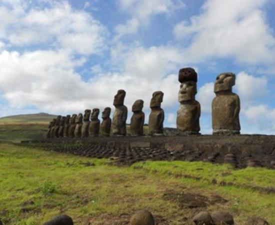 Restored statue platform with standing moai on the south coast of Rapa Nui. Note that one of the moai is adorned with a red scoria pukao. 