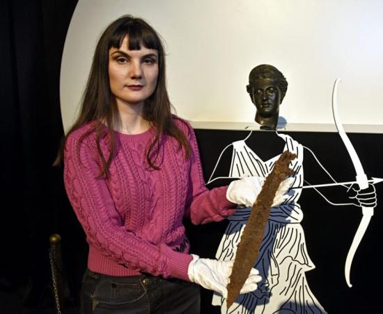 Dr. Marina Ugarković officially displaying the 4th-century BC sword found in a communal grave at the site of the ancient Greek city of Pharos on Hvar. 		Source: Joško Šupić / Cropix / Free Dalmatia